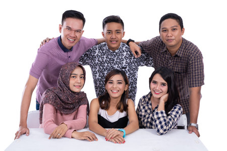 Cheerful group of friends hugging smiling friends