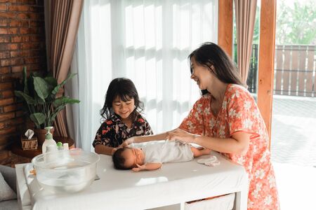 Mother and cute baby after bathingの写真素材