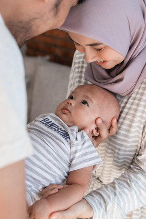 asian family with infant son together smilingの写真素材