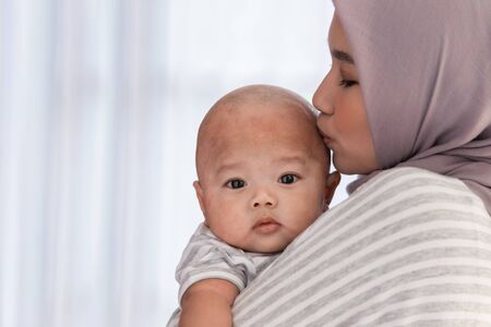 muslim smiling mother with her baby sonの写真素材