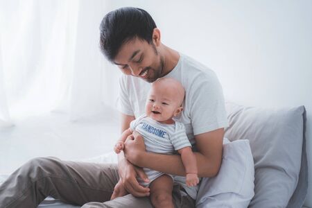asian father with his son playing togetherの写真素材