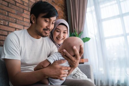 muslim parent with their newborn baby enjoy time togetherの写真素材