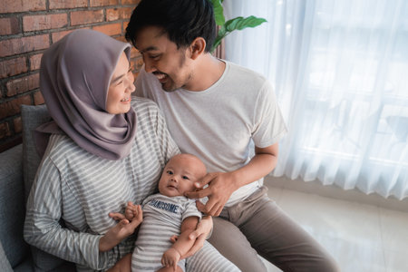 Muslim parent with their newborn baby enjoy time together
