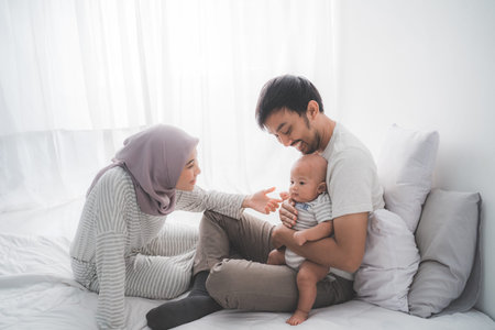 Muslim parent with their newborn baby enjoy time together
