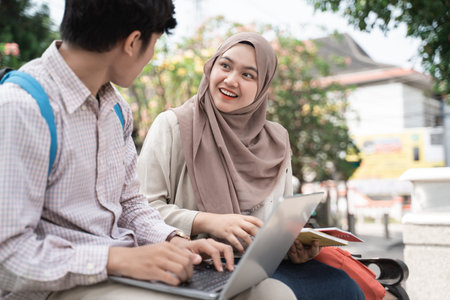 two asian teenage student enjoy chatting together with surprised expression