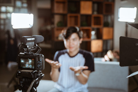 asian young man blogger make review using the camera on foreground