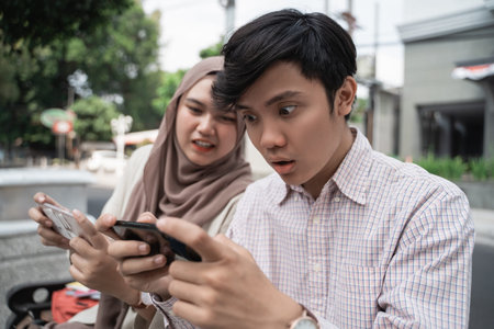 asian college student enjoy the game using smartphone