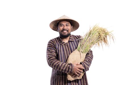 smile asian farmer holding paddy rice grain isolated on whiteの写真素材