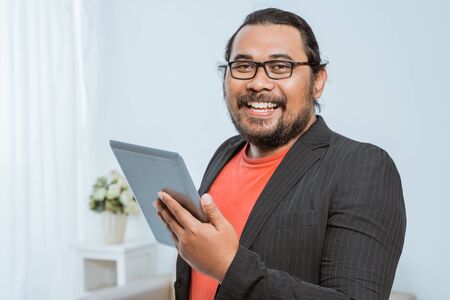 smiling asian entrepreneur looking at cameraの写真素材
