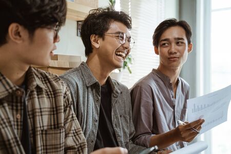 casual relaxed meeting between team in the officeの写真素材