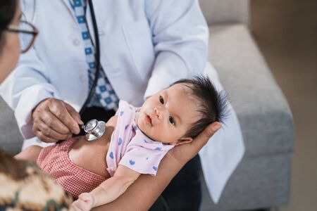 the doctor is immunizing a vaccine for babyの写真素材