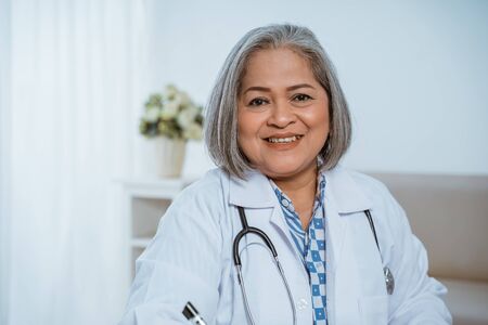 The senior doctor smiled wearing a uniformの写真素材