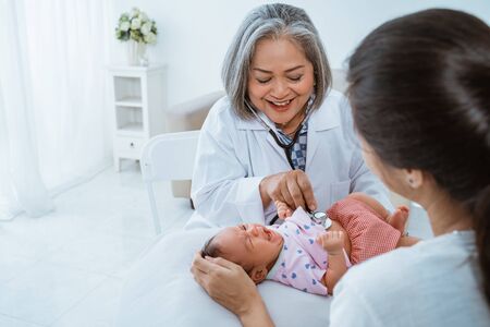 doctor examines a small babyの写真素材