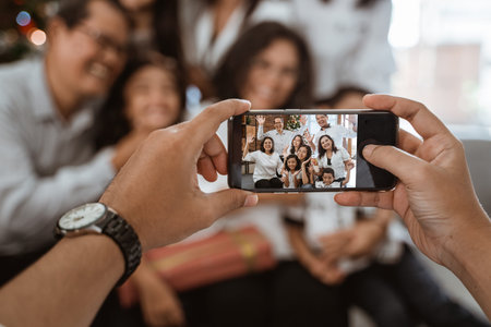 family taking photo together on christmasの写真素材