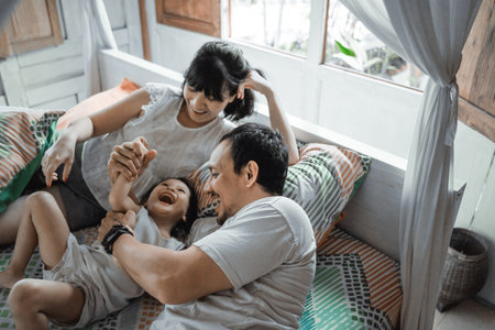 Asian happy family and child daughter laughing togetherの写真素材