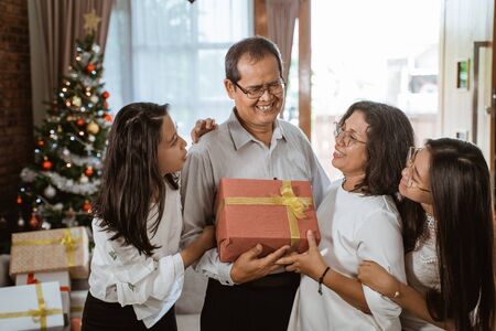 asian family with two daughter happy gift exchangeの写真素材