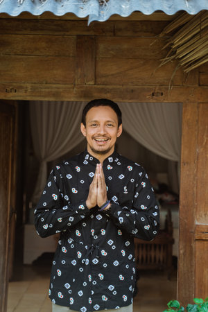 welcome greeting from asian young male at traditional house