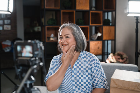 Old women making a video for her blog on cosmetics