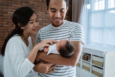 happy young parent when relaxing with little daughterの写真素材