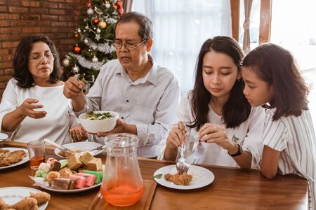 family lunch on christmas day with mother and grandparentの写真素材
