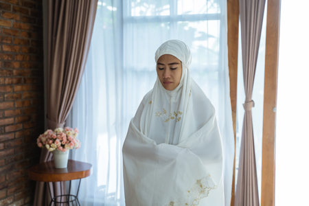 Muslim woman praying wearing hijab