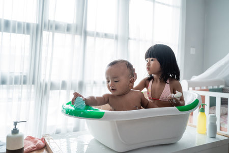 child sibling taking bath together at home