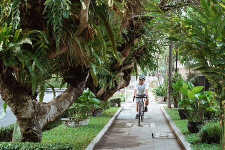 Young man wearing bike helmets when riding bicycleの写真素材