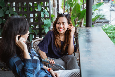 two young women cyclists meeting at the cafeの写真素材