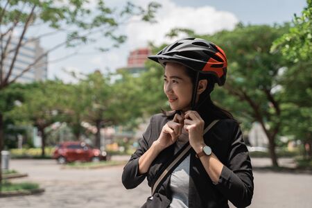 asian young woman wearing helmet bike for safetyの写真素材