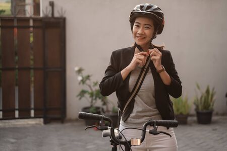 asian young woman wearing helmet bike for safetyの写真素材