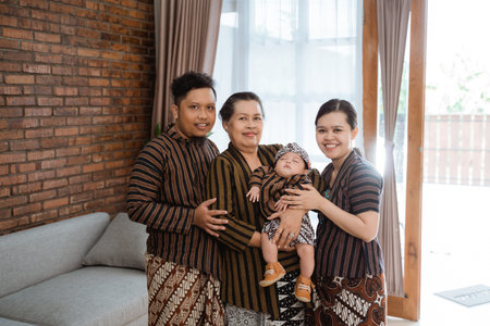 portrait of asian happy family wearing javanese batik heritage