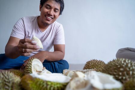 asian man enjoy eating durian fruitの写真素材