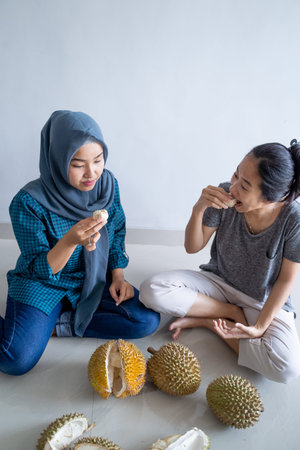 muslim friend eating durian fruit