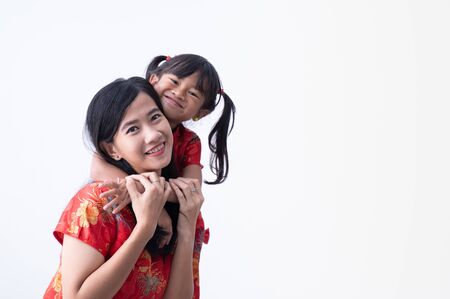 asian Chinese daughter and mother smile and hug togetherの写真素材