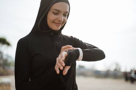 runner looking at heart rate monitor smart watchの写真素材