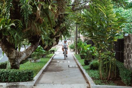 asian young man wearing bike helmets when riding bicycleの写真素材
