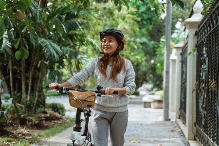 Asian young women walk on folding bikesの写真素材
