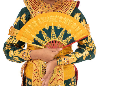 cropped picture of woman Balinese dancers standing hold a fan
