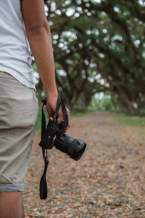 man hand holding a camera taking picture