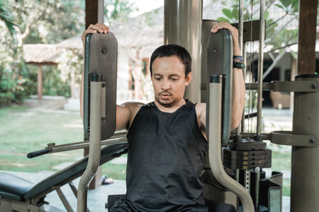 Asian young man doing chest exercise