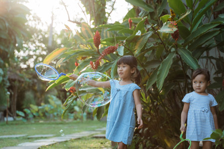 active little girl playing big bubble