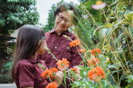 granddaughter and grandmother looking flowers