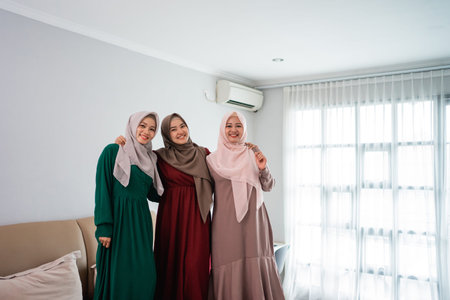 having fun while spend time three moslem women standing in bed