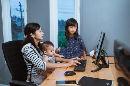 businesswoman working while taking care children