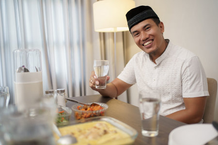 man with traditional muslim clothes breakfasting dinner