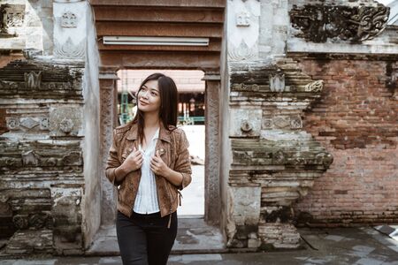 asian woman enjoying traveling to exotic cultural placeの写真素材