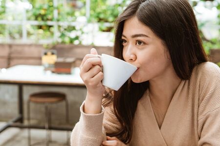 attractive woman enjoy drinking coffee by herself in cafeの写真素材