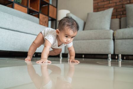 asian baby learn to crawlの写真素材