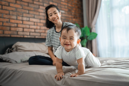mother looking at her baby crawling