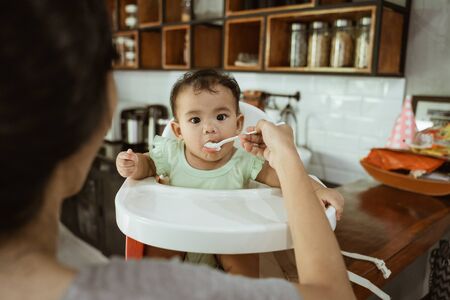 mother feeding babyの写真素材
